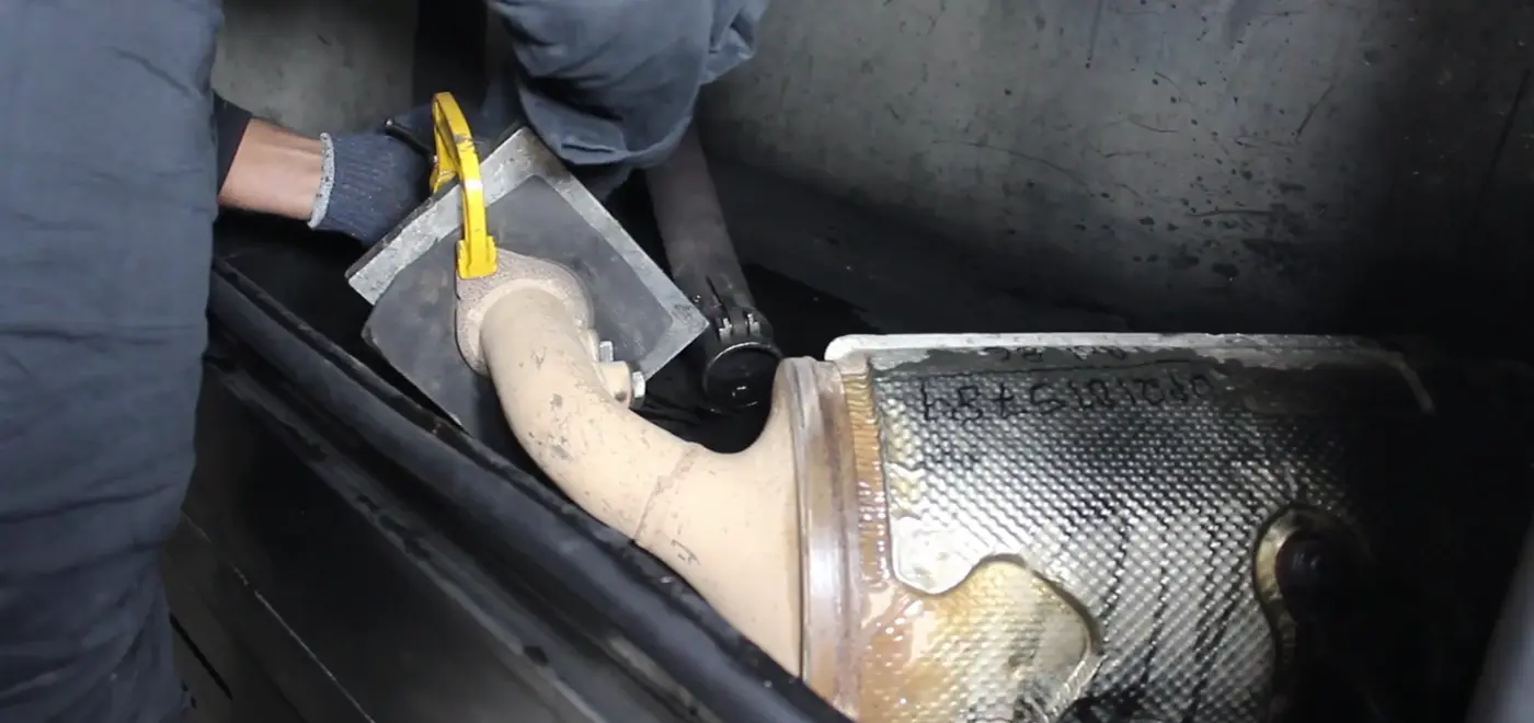Extracted filter being handled for loading into the cleaning machine